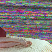 colorful background behind legs lying on a bed